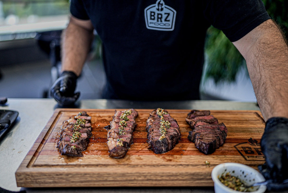 At the table. Sliced picanha with sauce alongside, on a board
