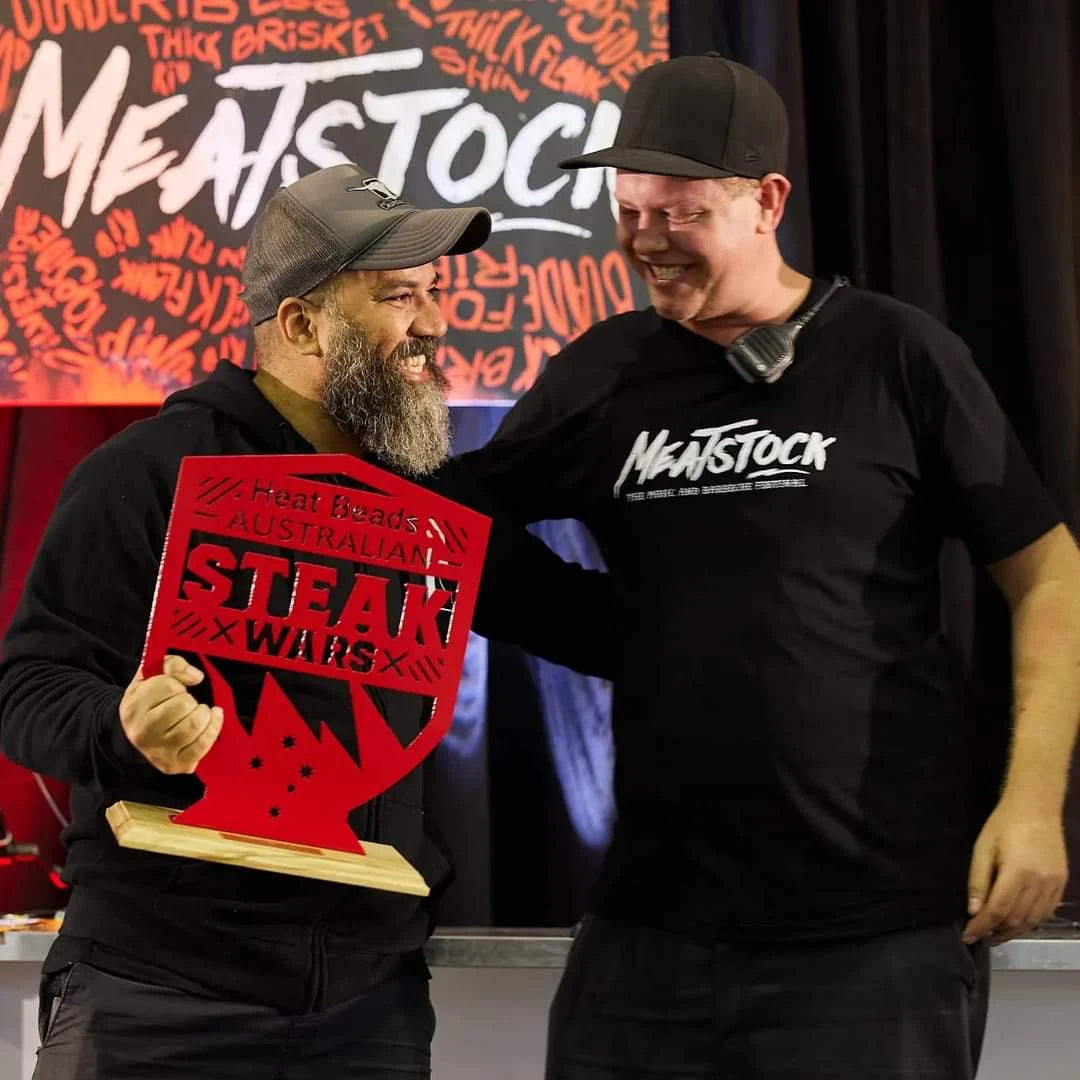 Adriano Andrade smiling and holding an Australian Steak Wars trophy at Meatstock
