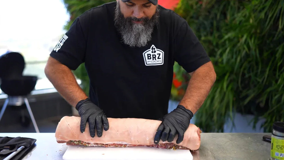 The roll. Adriano rolling the seasoned pork belly into porchetta