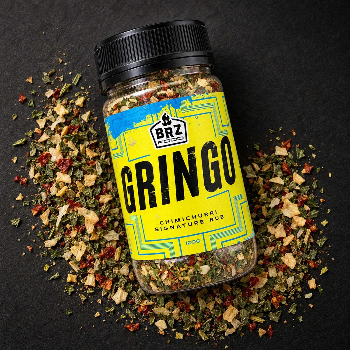 Studio composition. Gringo chimichurri jar surrounded by dried seasoning on a charcoal background.