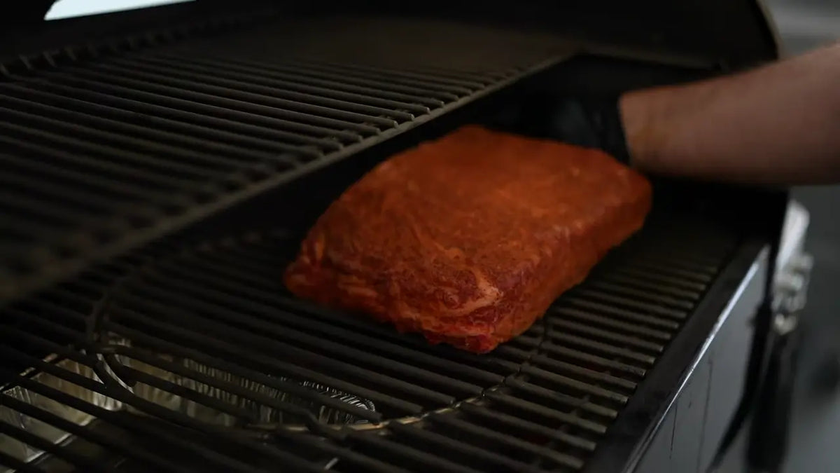 In the smoker. Adriano placing the Xtra Mojo seasoned beef ribs in the smoker